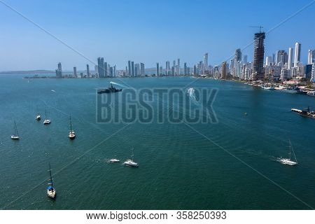 Aerial View Of The Beautiful Yachts Drifting In The Bay. A Warship Patrols The Gulf