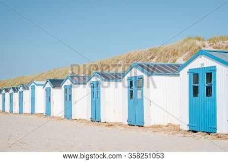 Texel Island Netherlands, Blue White Beach Hut On The Beach With On The Background The Sand Dunes Of