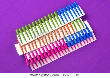 On A Purple Background Hair Clips Of Different Colors In Sets On A Cardboard Frame