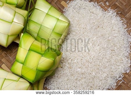 Ketupat Casing And Rice In Bamboo Container. Traditional Malay Delicacy During Malaysian Eid Festiva