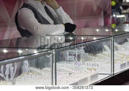 Girl Near A Counter Salesman In A Jewelry Store. Sale