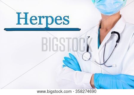 Doctor In Medical Clothes On A Light Background With The Text Herpes. Medical Concept.