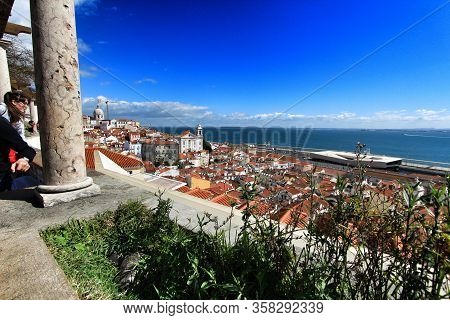 Lisbon, Portugal- March 4, 2020: Tourists Enjoying At The Beautiful Santa Luzia Viewpoint In Lisbon 