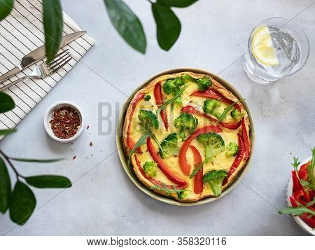 Italian Fritata With Broccoli, Bell Pepper And Arugula On A Gray Stone Background. Delicious Homemad