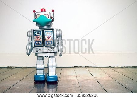 retro robot with text CIVID 19 on a old wooden floor