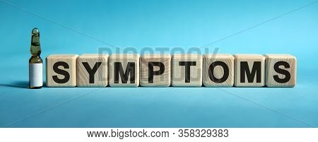 Symptoms - Text On Cubes. Drug In Ambula To Reduce Disease Symptoms On A Blue Background