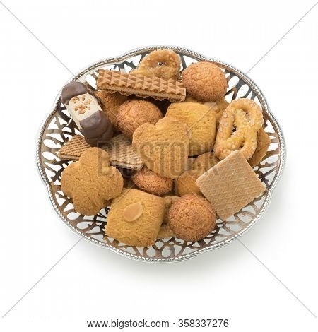 Bowl with a variation of dutch traditional cookies isolated on white background 