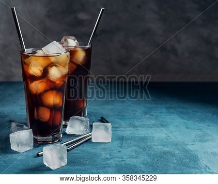 Cold Brew Coffee In A Glass With Metal Straw On A Dark Background.iced Coffee With Ice Cube.