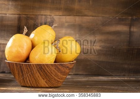Spondias Purpurea - Delicious Tropical Fruit. Wood Background