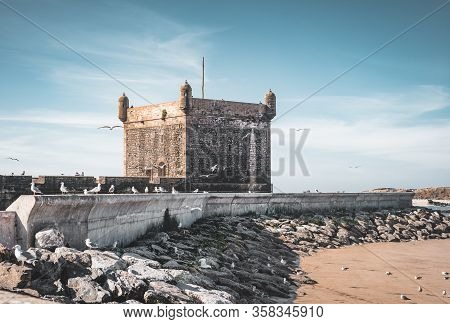 Sqala Du Port, A Defensive Tower At The Fishing Port Of Essaouira, Morocco Near Marrakech. Blue Sky 
