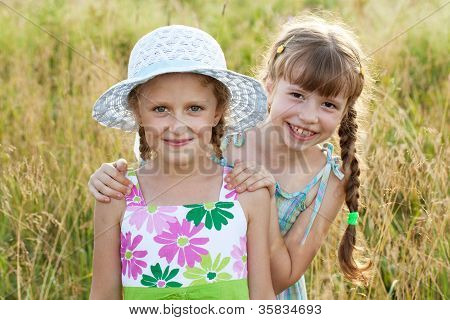 Two girls - girlfriends in summer dresses