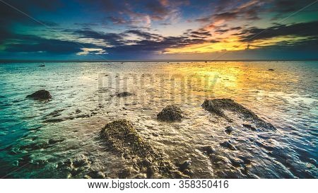 Swallow Of The Wadden Sea In The Netherlands During Sunset With Wid Angel View And Colorful Clouds.