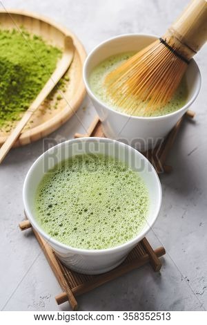 Matcha Green Powder And Tea On Gray Concrete Background