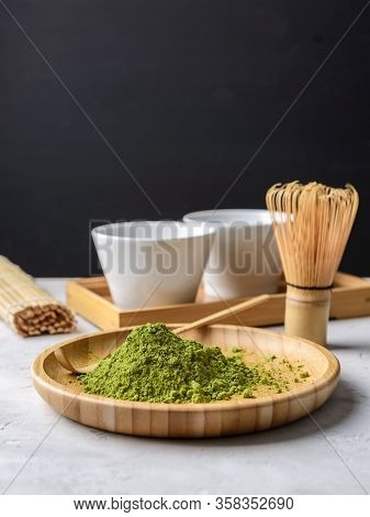 Matcha Green Powder And Tea On Gray Concrete Background