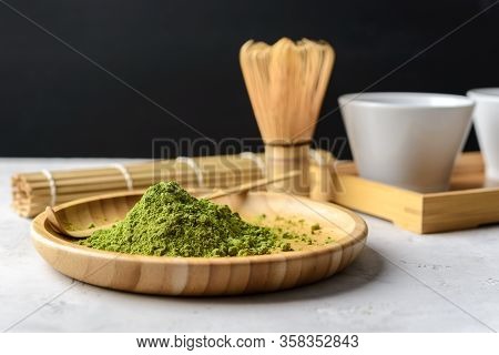 Matcha Green Powder And Tea On Gray Concrete Background