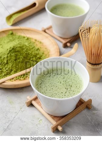 Matcha Green Powder And Tea On Gray Concrete Background