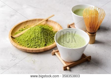 Matcha Green Powder And Tea On Gray Concrete Background