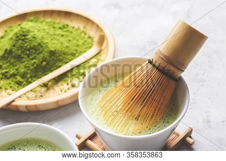 Matcha Green Powder And Tea On Gray Concrete Background