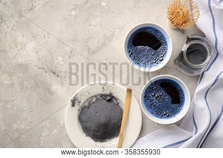 Blue Matcha Tea In Two White Cup , Wooden Tray, Bamboo Tavan And Tasaku, Powder On White Gray Backgr