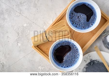 Blue Matcha Tea In Two White Cup , Wooden Tray, Bamboo Tavan And Tasaku, Powder On White Gray Backgr
