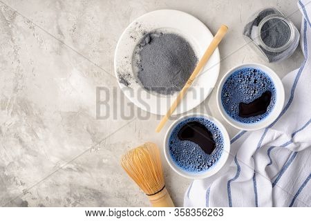 Blue Matcha Tea In Two White Cup , Wooden Tray, Bamboo Tavan And Tasaku, Powder On White Gray Backgr