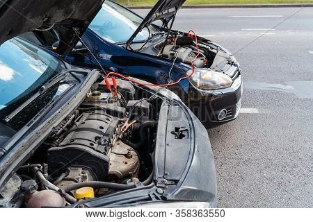 Jump Cables On Car Low Power Battery. Broken Car Start Attempt. Selective Focus.