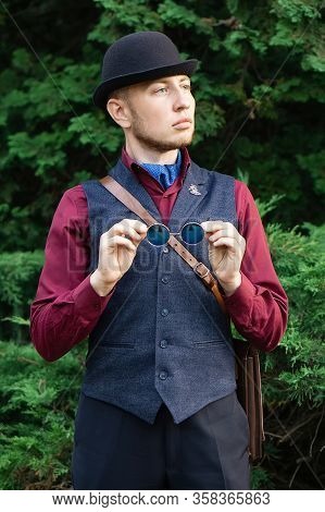 Victorian Steampunk Retro Adwenturer Guy In Bowler Hat And Blue Glasses