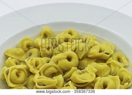 Tortellini In Brodo (broth) Isolated On White. Traditional Italian Pasta. Closeup
