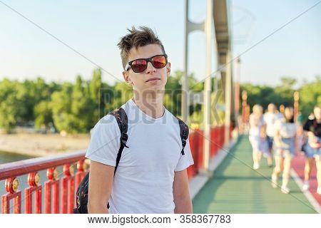 Teen Boy 15 Years Old With Fashionable Hairstyle Sunglasses Looking At Camera, Standing On Footbridg