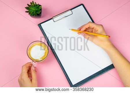 Tablet With White Flattery Next To Which Stands A Green Plant, Hand Holds A Pencil And Draws On A Sh