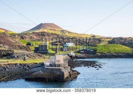 Old Buildings And Boat At The Coastline Of Island Of Heimaey