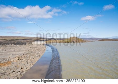 The Spillway Of Spordoldulon Reservoir In Iceland On A Sunny Summer Day