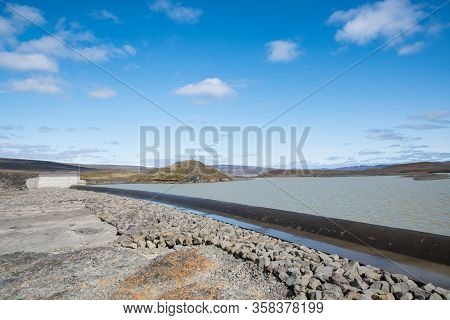 The Spillway Of Spordoldulon Reservoir In Iceland On A Sunny Summer Day