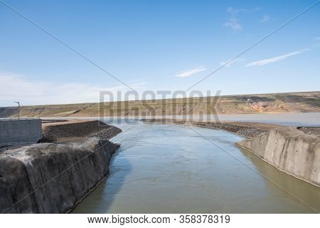 The Outlet Canal Of Budarhals Hydroelectric Power Plant In Iceland On A Sunny Summer Day