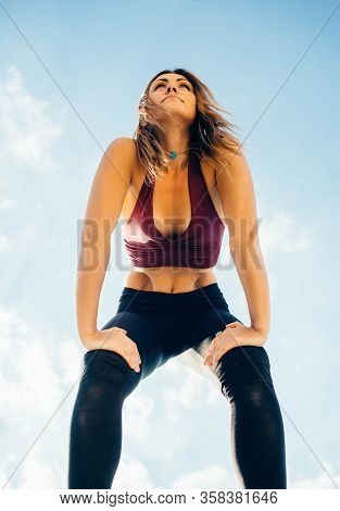 Young Woman Practices Yoga Outside. Calm Peaceful Girl Stands With Her Hands On Her Legs Above Knee.