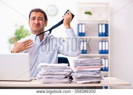 Young male employee unhappy with excessive work