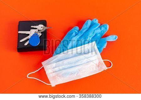 Medical Mask And Gloves Lie With Keys On A Background Of Lush Lava Color
