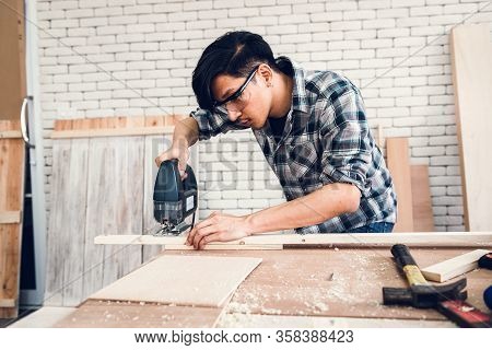 Carpenter Man Is Working Timber Woodworking In Carpentry Workshops, Craftsman Is Measuring Timber Fr
