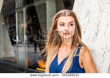 Young Eastern European American Woman With Long Brown Hair, Wearing Blue Sleeveless, V Neck Dress, S