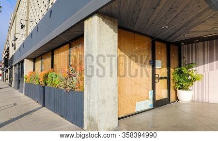 Corner Business With Windows Boarded Up With Plywood