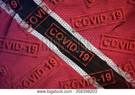 Trinidad And Tobago Flag And Many Red Covid-19 Stamps. Coronavirus Or 2019-ncov Virus Concept