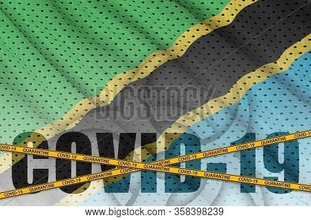 Tanzania Flag And Covid-19 Inscription With Orange Quarantine Border Tape. Coronavirus Or 2019-ncov 