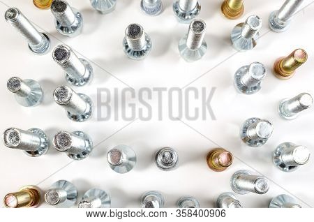 Nuts And Upright Studs And Bolts For A Car On A Table With A Place For Inscription