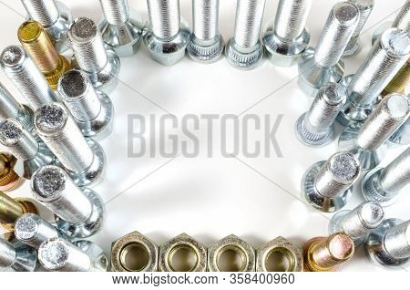 Nuts And Upright Studs And Bolts For A Car On A Table With A Place For Inscription