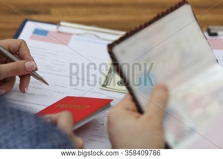 Woman Fills Out Visa Application Form In Usa. Obtaining Passport At Embassy. Payment Consular Fee In