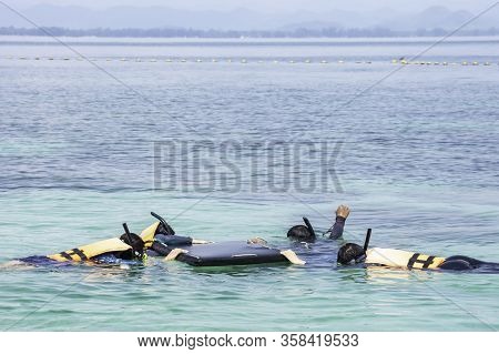 Tourists Snorkel The Beautiful Sea At Koh Talu , Prachuap Khiri Khan In Thailand.