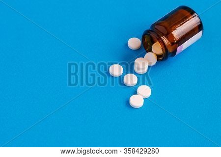 Tablets Are Poured Out Of The Bottle. Selective Focus.