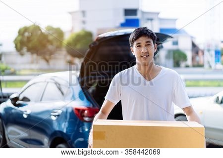 Delivery Man Carrying Cardboard Box For Sending To Receiver Customer By Transportation System Hatchb