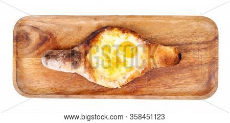 Georgian Cuisine - Top View Of Adjarian Boat-shaped Khachapuri With Cheese, Butter And Egg Yolk On W