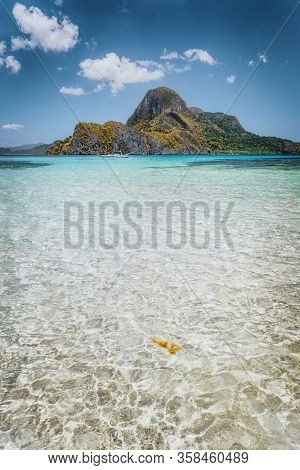 El Nido Shallow Bay With Crystal Clear Water And Cadlao Island On Sunny Day, Palawan, Philippines